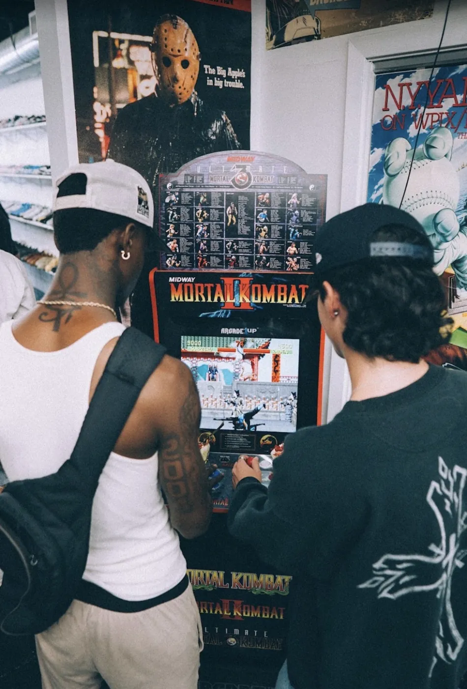 Two customers playing the arcade