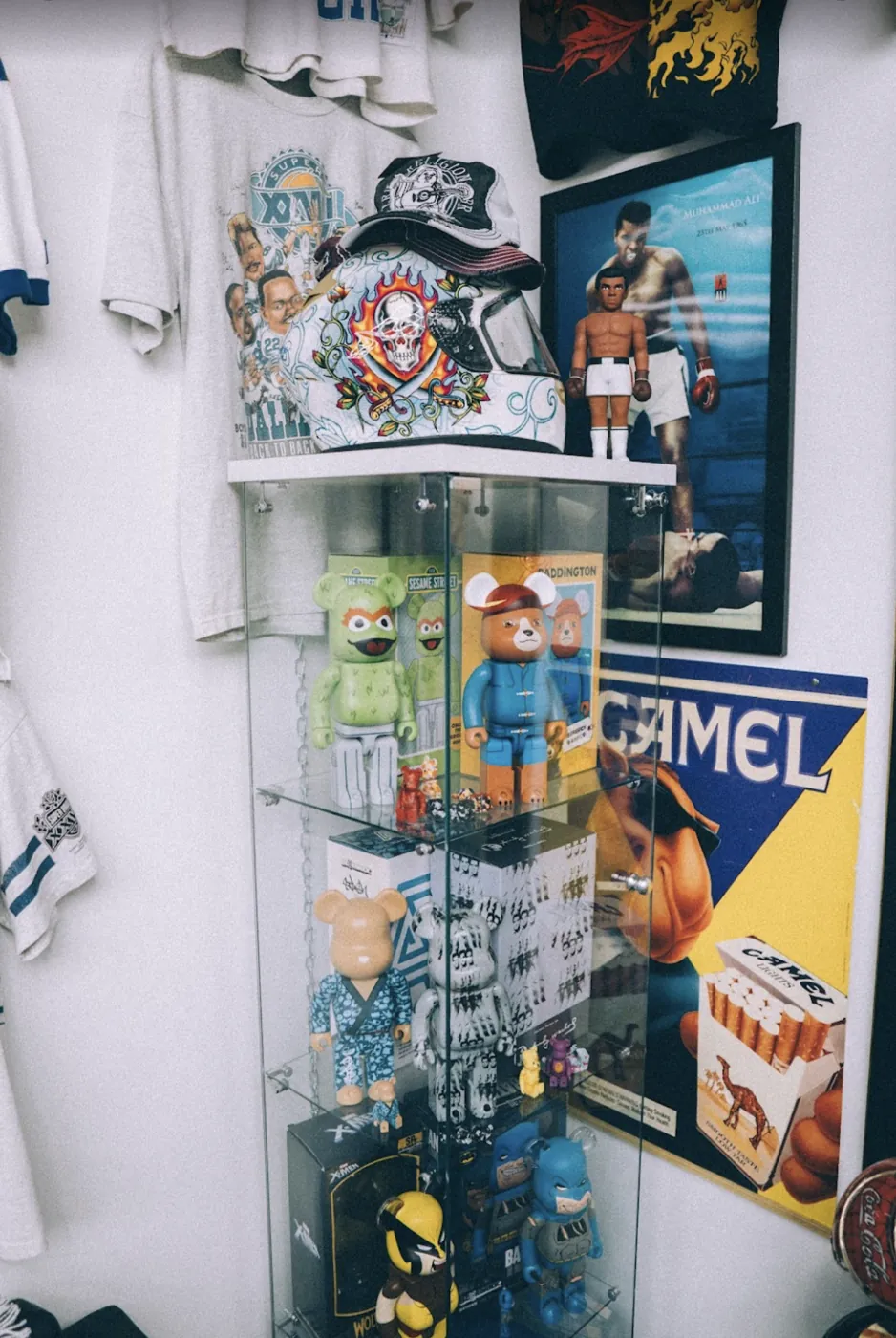 Bearbrick display case, vintage tees and posters