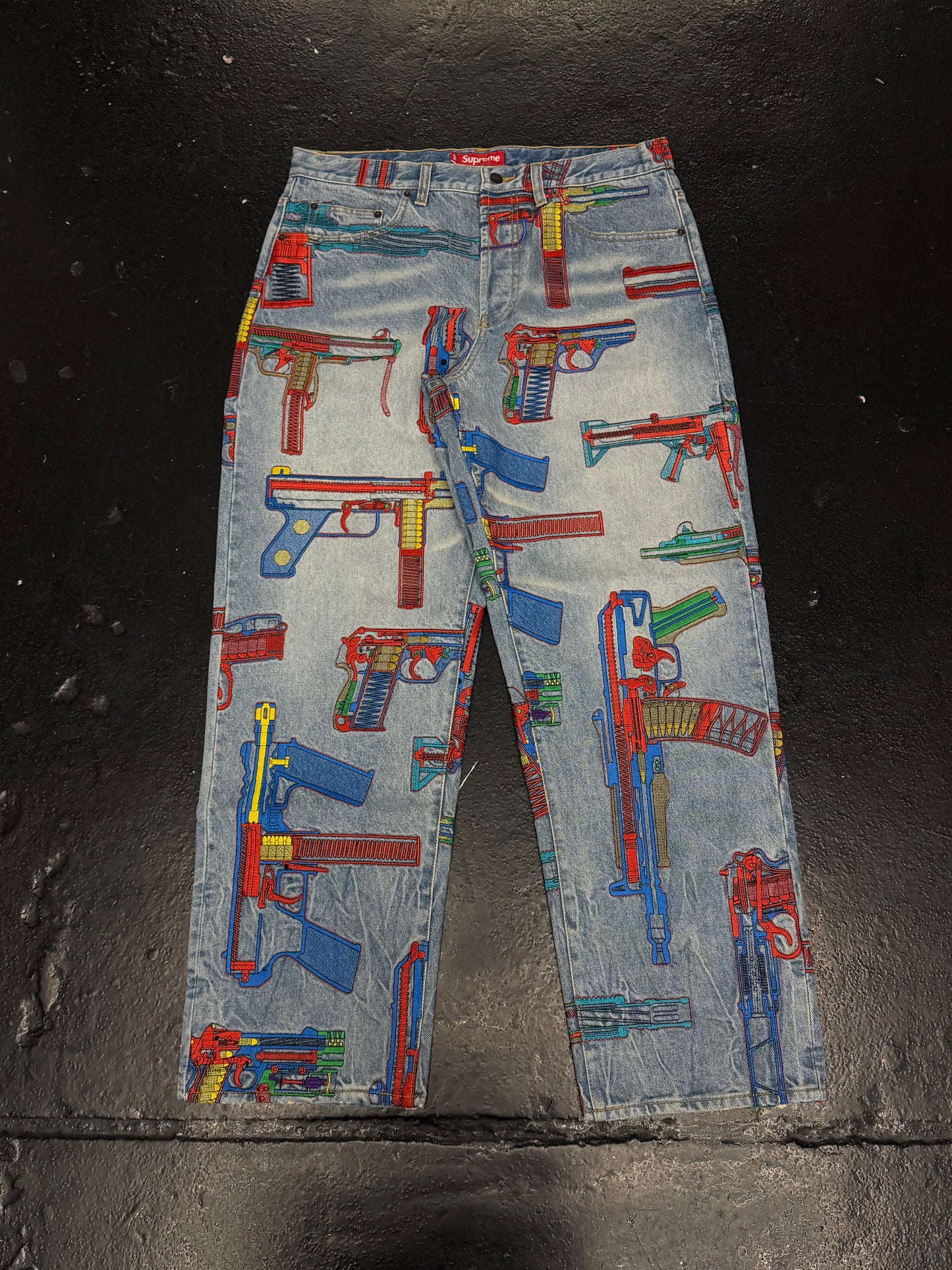 SUPREME GUNS EMBROIDERED JEANS (PRE-OWNED)