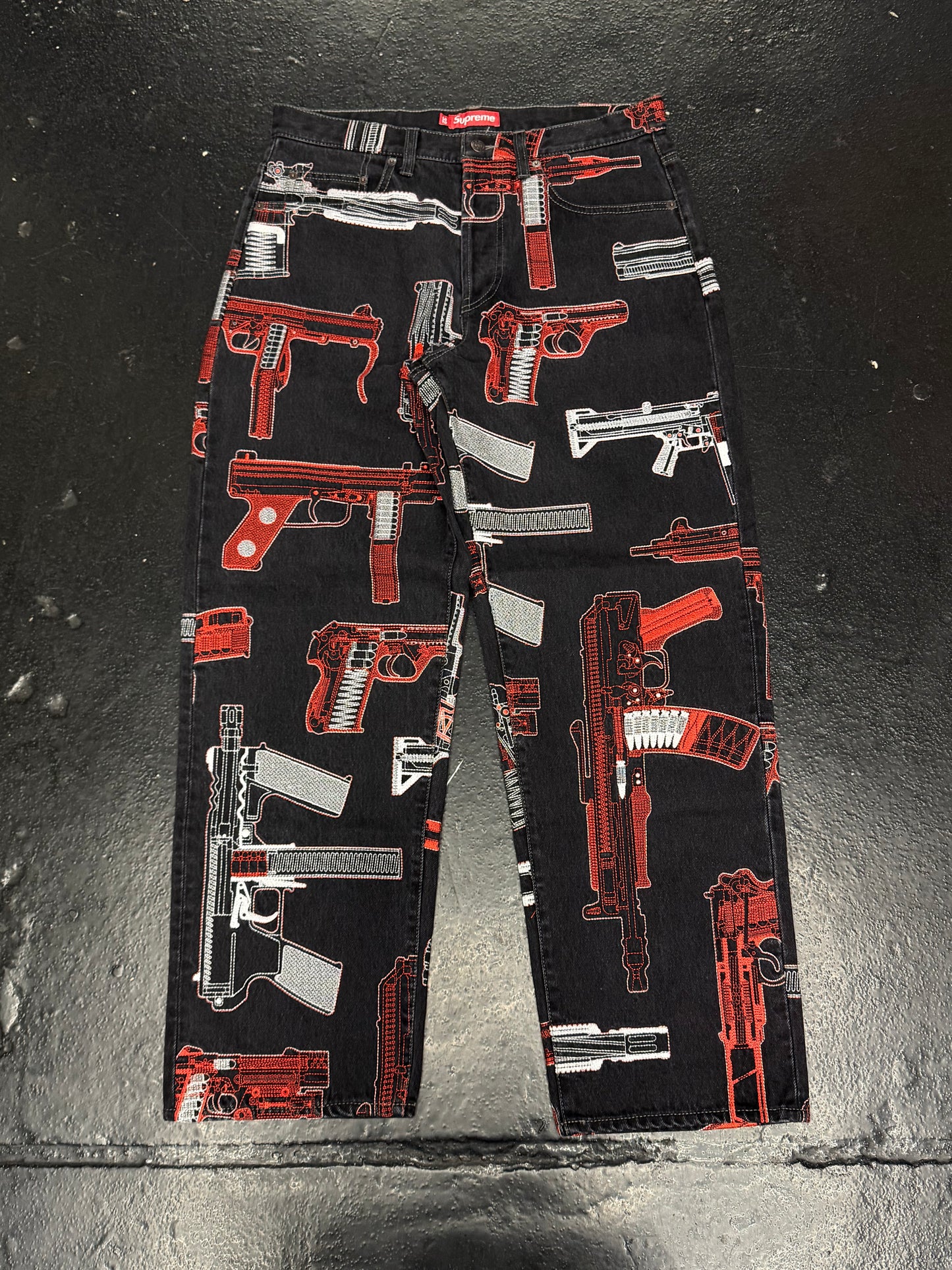 SUPREME GUNS EMBROIDERED JEANS (PRE-OWNED)