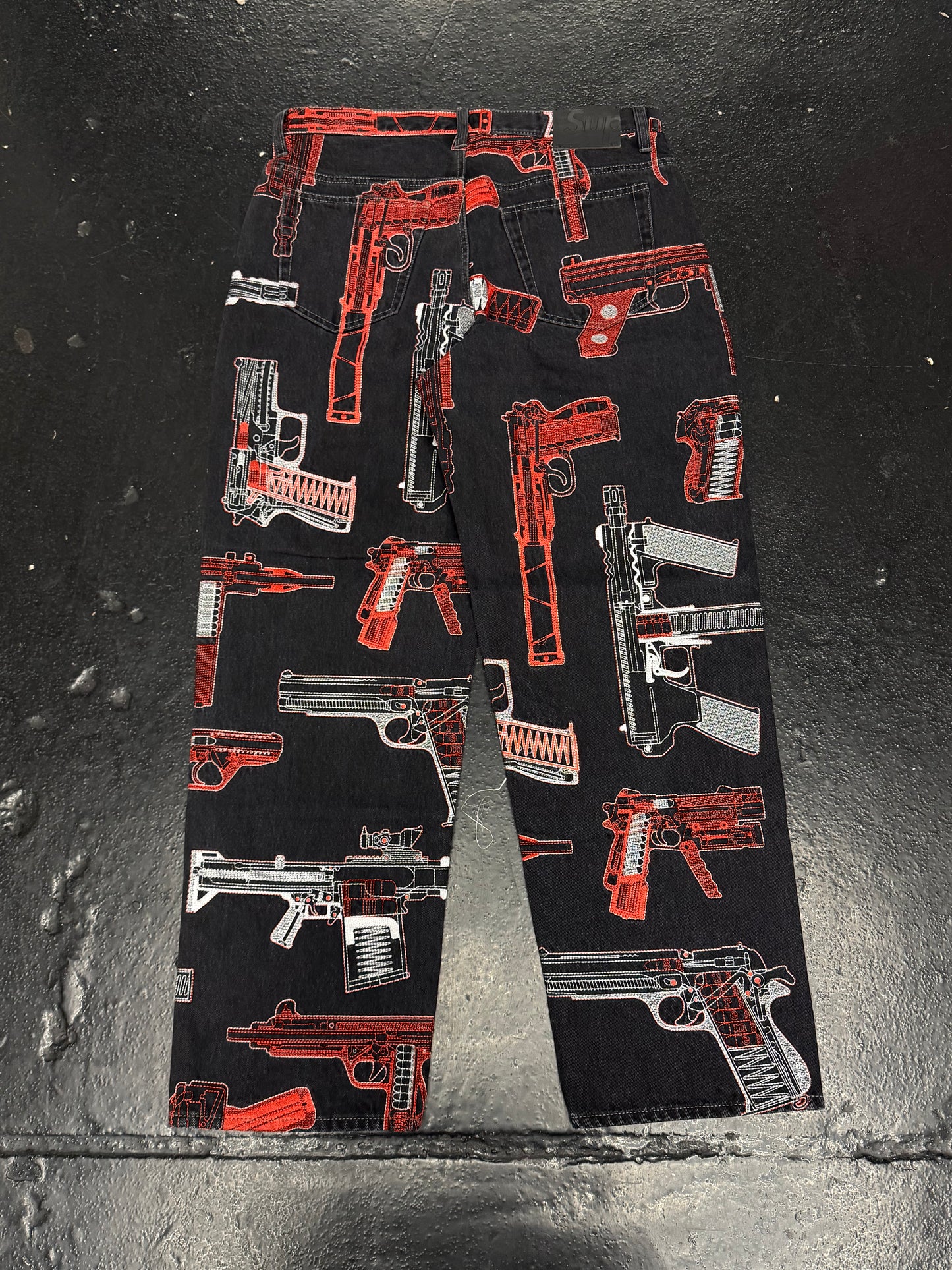 SUPREME GUNS EMBROIDERED JEANS (PRE-OWNED)